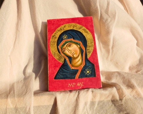 Hand-painted Virgin Mary icon on easel, a unique piece of luxury sacred art. Crafted with egg tempera and authentic gold leaf in traditional Byzantine style.