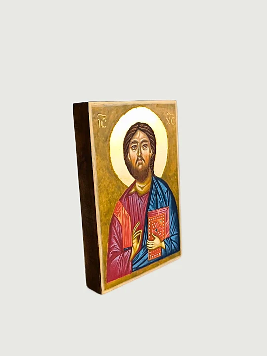 Christ Pantocrator Icon with Gospel – side view of hand-painted Orthodox Byzantine religious icon showing the thickness of seasoned linden wood panel stained with natural honey finish. Premium Christian home altar art, Catholic and Orthodox sacred decoration, genuine gold leaf, traditional egg tempera craftsmanship.