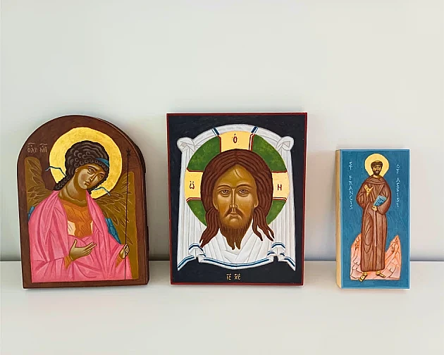 Hand-painted wooden icons depicting Jesus, an Angel, and St. Francis in the Orthodox Christian style.
