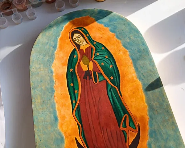 Hand-painted religious icons of Our Lady of Guadalupe, traditional Mexican Catholic art on wood panel with gold accents.