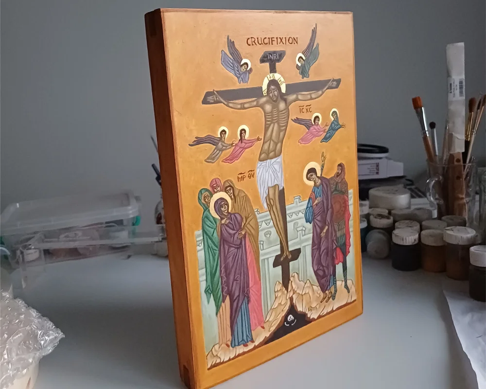 Traditional Orthodox Crucifixion Icon hand-painted with egg tempera and gold leaf on a wooden board.