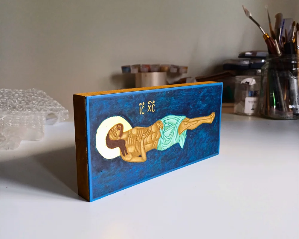 Hand-painted Jesus in the Tomb Icon on linden wood with 24k gold leaf in an artist's studio.
