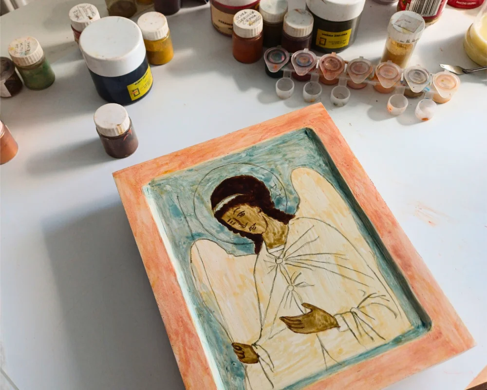 An early stage of an Archangel Gabriel Handpainted Icon in egg tempera showing his wings, blue headband, and staff.