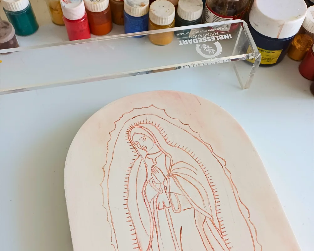 Authentic hand painted catholic icons in the making: A traditional sketch of Our Lady of Guadalupe on custom wooden icon boards before egg tempera painting.
