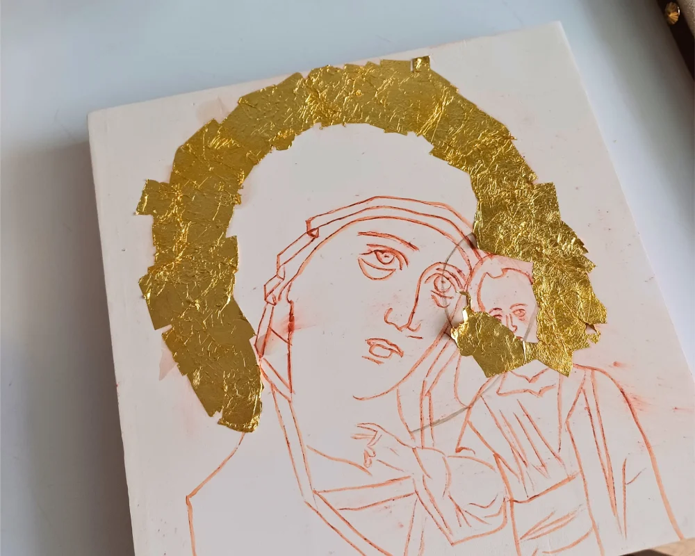 Gold leaf gilding process of a hand painted Our Lady of Kazan icon on a traditional lime wood panel with gesso.