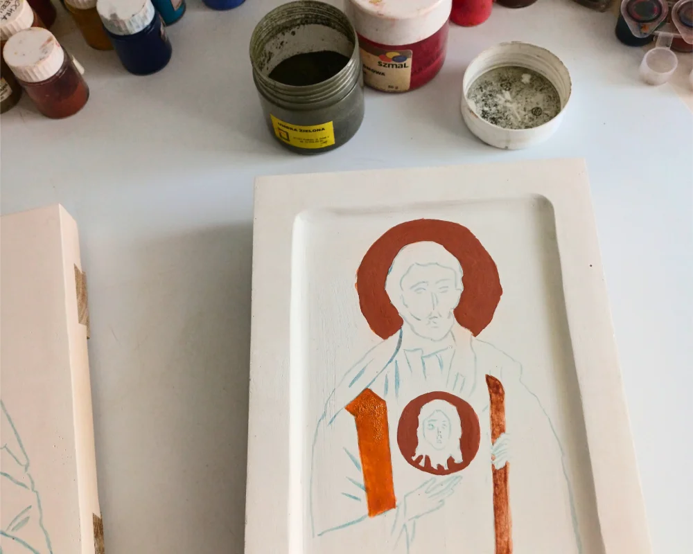 Clay bole application on the halo and Mandylion of a hand-painted St. Jude Thaddeus icon before gold leaf gilding.
